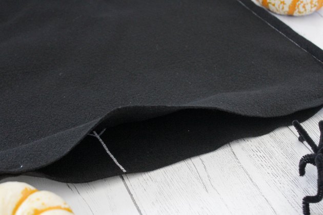 This not so itsy-bitsy spider DIY web pillow will create that spooky vibe you're going for.