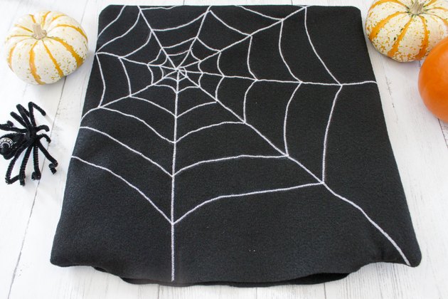This not so itsy-bitsy spider DIY web pillow will create that spooky vibe you're going for.