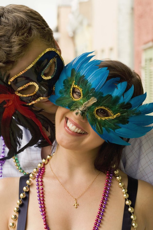 Intimate couple with masquerade masks