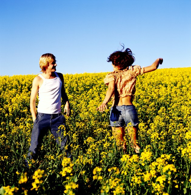 Young couple standing together in a field of flowers