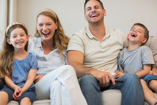Happy family sitting on sofa