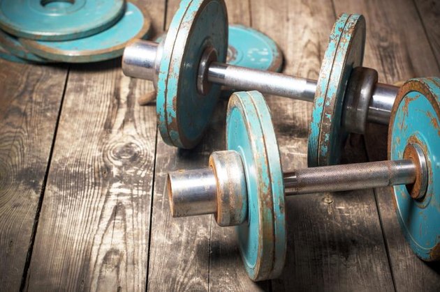 The old dumbbell on the wooden floor. Retro