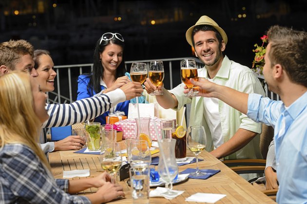 Group of young friends drinking beer outdoors