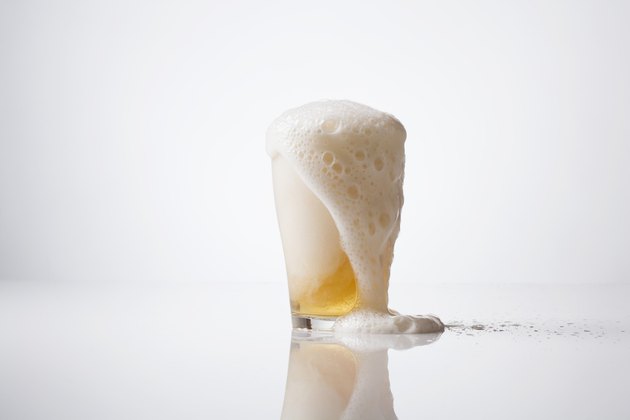 Overflowing glass of beer