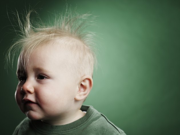 One year old boy with hair sticking up.