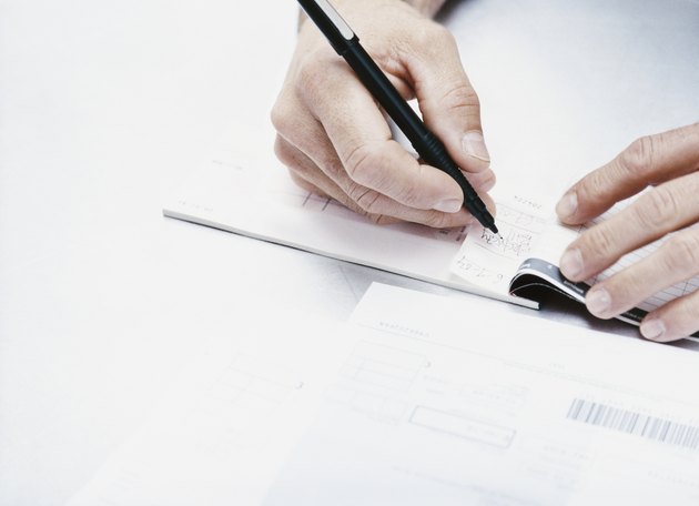 Adult Writing in a Cheque Book