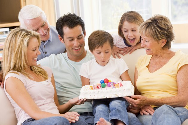 Family in living room with birthday cake