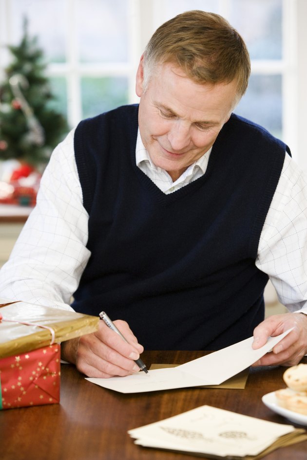 Man writing greeting cards