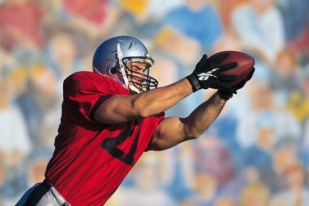 Football receiver catching ball
