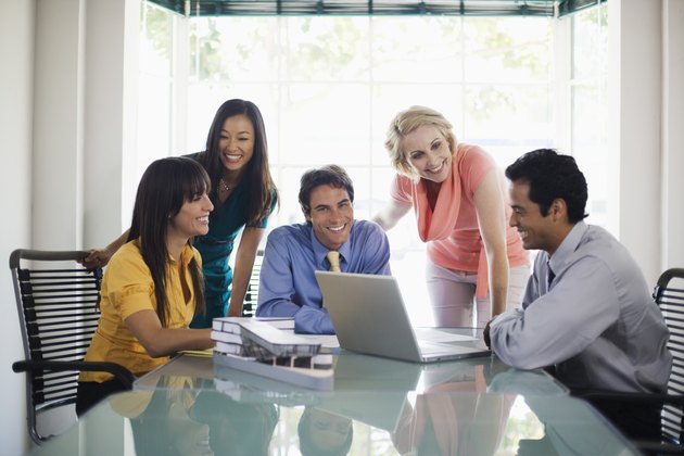 Smiling businesspeople with laptop computer