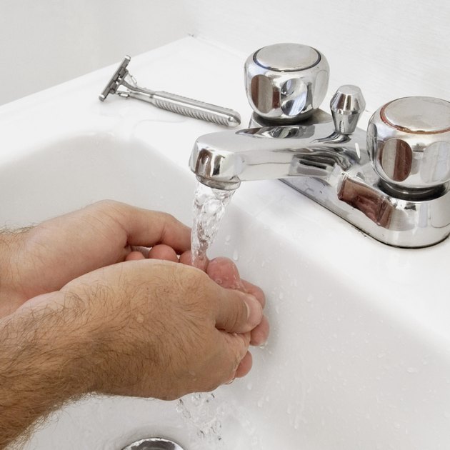 Close-up of man washing his hands, part of