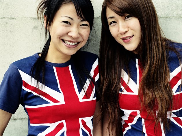 Two young women wearing Union Jack t-shirts, close-up, portrait