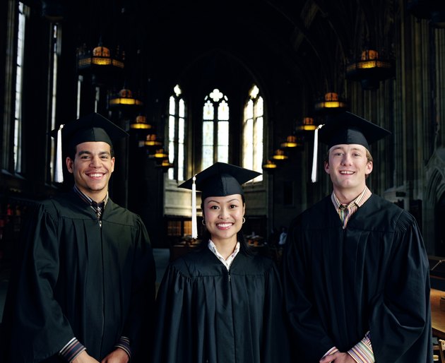 Group of graduates standing in library, portrait