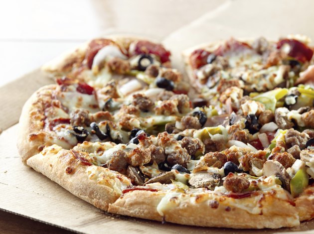 pizza sitting on cardboard box