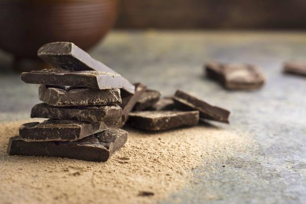 pieces of dark chocolate stacked on grunge background