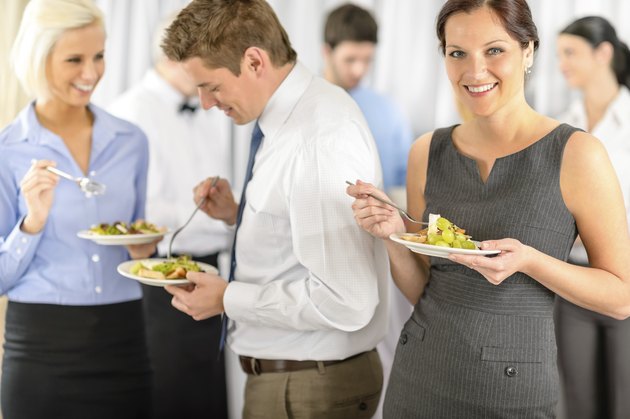 Smiling business woman during company lunch buffet