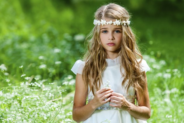Beautiful pre teen in green field.
