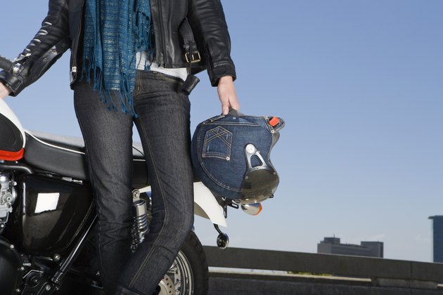Woman motorcyclist with motobike