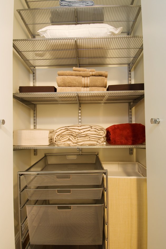Towels arranged on shelves in household closet