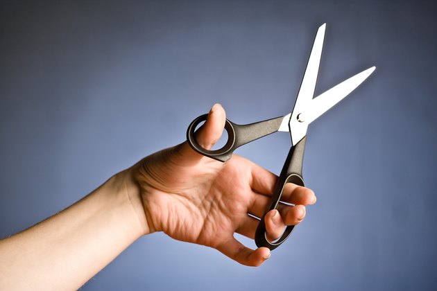 Person holding scissors