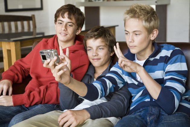 Teenage boys with digital camera