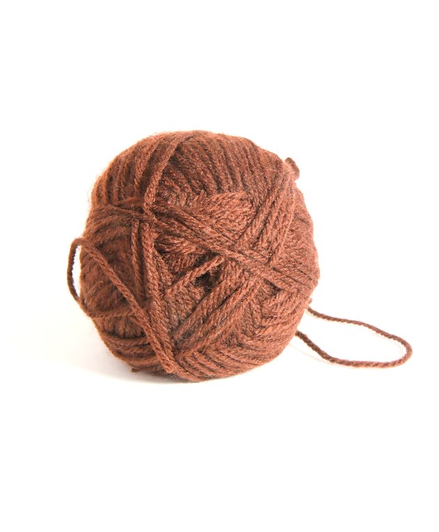 Ball of brown wool thread for knitting isolated