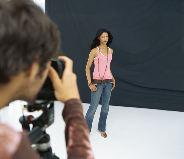 Rear view of a photographer photographing a young woman