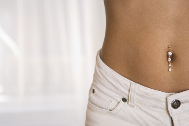 Woman's waist with pierced belly button