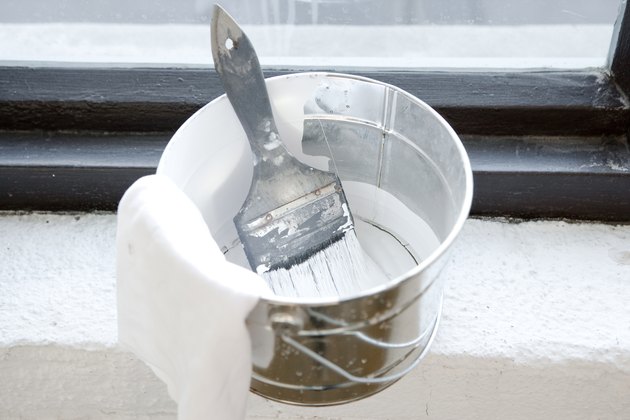 Paintbrush in bucket of paint