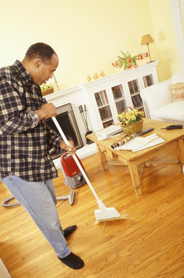 Man sweeping living room floor
