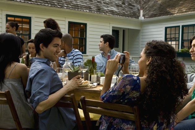 Hispanics at outdoor garden party at country home