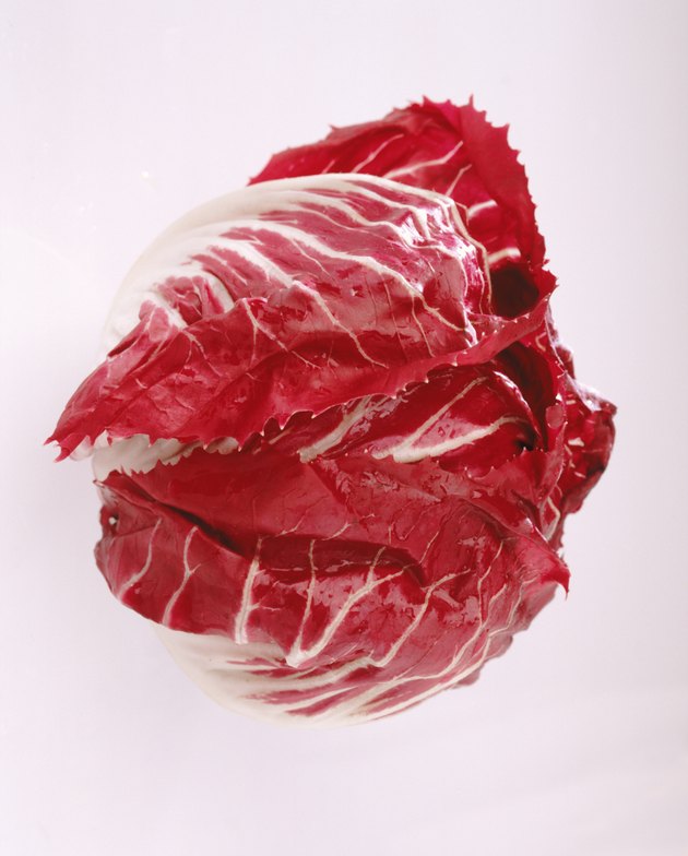 Radicchio leaf against white background, close-up