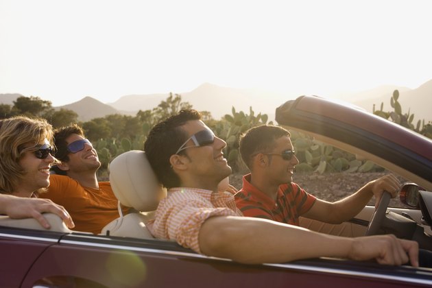 Friends Riding in Convertible Through Desert