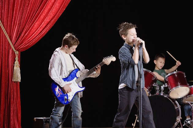 Multi-ethnic boys performing in band