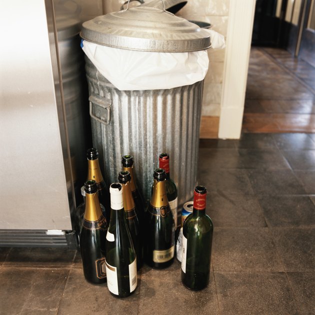 Empty champagne bottles by dustbin, elevated view