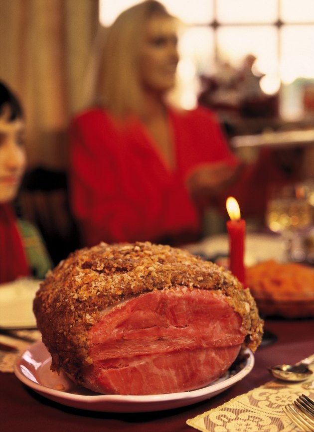 close-up of pot roast on a dining table with people sitting (blurred)