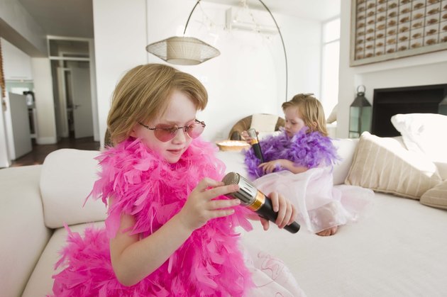 Twin girls playing dress-up