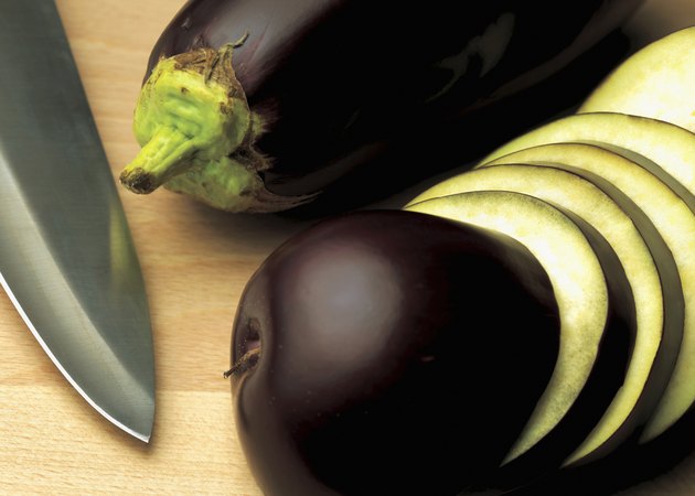 close-up of sliced aubergine with a knife