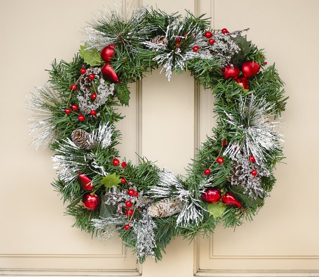 "Christmas wreath with cones, baubles, and berries"