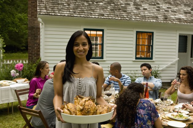 Hispanics at outdoor garden party at country home