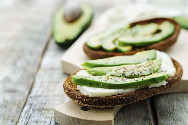 sandwich of rye bread with avocado and goat cheese. tinting. selective focus
