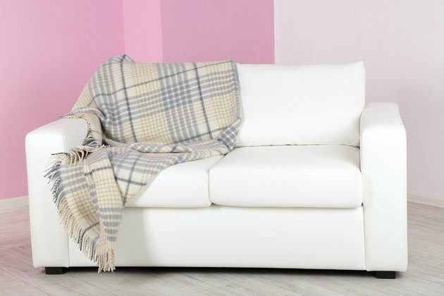 White sofa in room on pink wall background