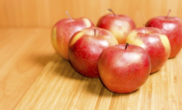 Fresh red apples on a wooden background