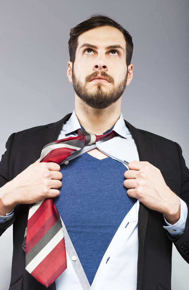 Young businessman acting like a super hero