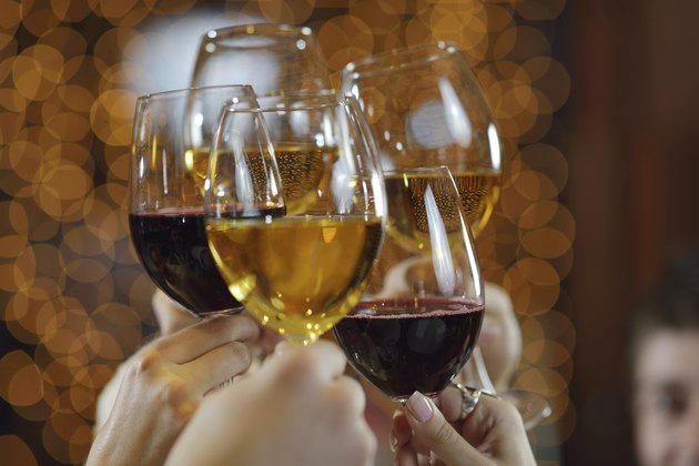 Hands holding the glasses of champagne and wine