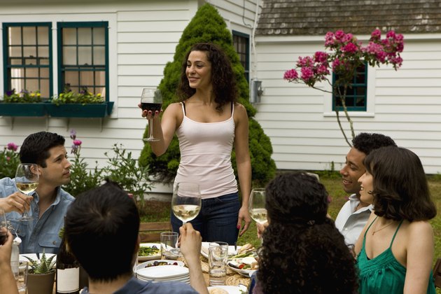 Hispanics at outdoor garden party at country home