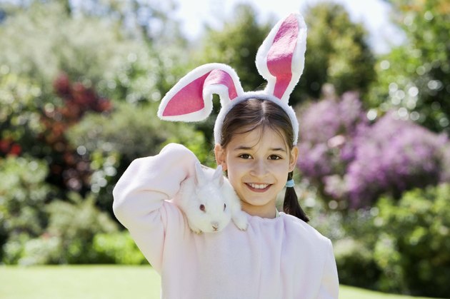 Girl in costume holding rabbit