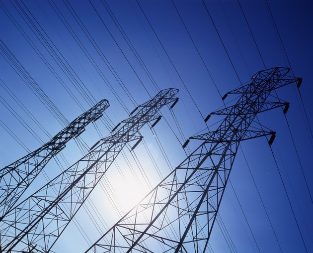 low angle view of high tension cable towers