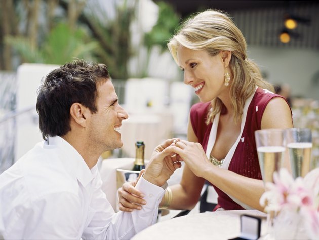 Side view of a mid adult man proposing to a mid adult woman