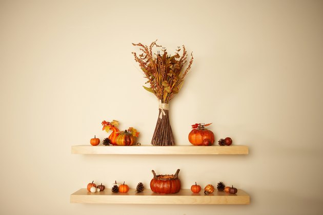 Thanksgiving decorations on shelves on wall